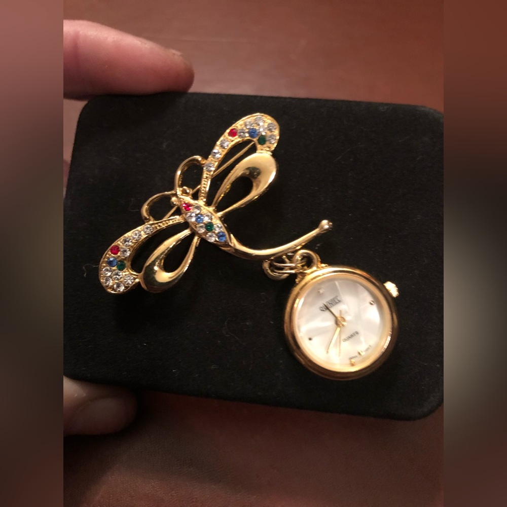Quintel watch broche